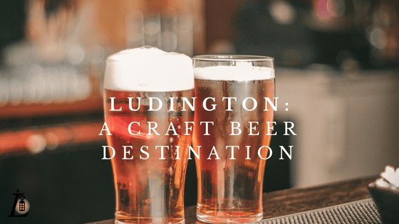 Two glasses of craft beer on a bar with the text "Ludington: A Craft Beer Destination."